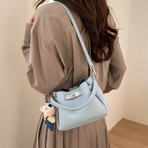 Light blue lychee leather bucket bag with silver turn-lock and cute bear charm