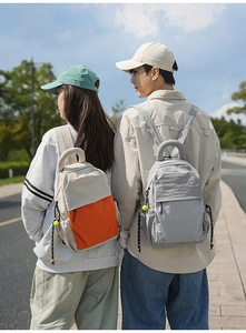 Outdoor leisure backpack in beige and orange nylon fabric with rope zipper details