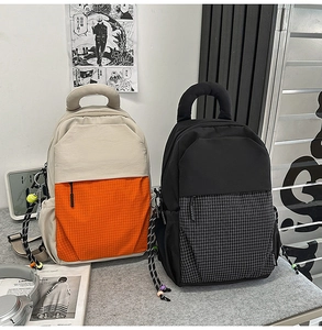 Detail of multi-functional backpacks with checkered pockets and decorative beaded drawstrings