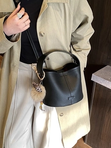 Classic black litchi pattern leather bucket bag with stylish leopard bow and fur ball charm