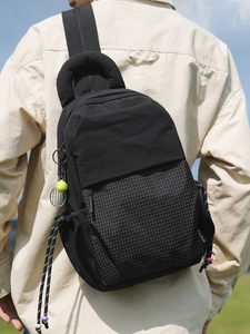 Versatile black commuter backpack with plaid splice and tennis racket charm accessory