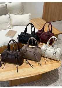 Detail of five vintage baguette bags in multiple colors with unique drawstring handles