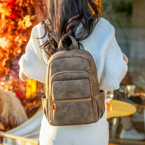 Detail view of the brown vintage PU leather backpack with gold metal magnetic buckle