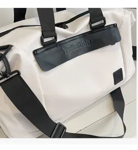 Close-up of white travel bag detail featuring comfortable fabric and branded leather trim
