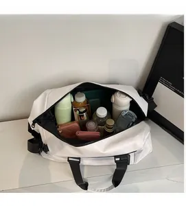 Detail view of large white travel bag showing spacious interior with various essentials