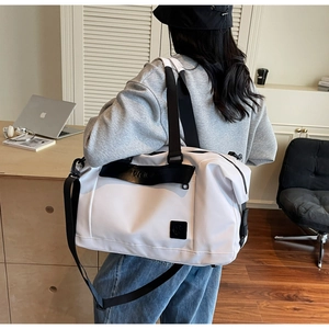 Detail view of large white travel bag with wet dry separation for gym and sports
