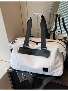 White large capacity travel duffel bag with black handles and detachable shoulder strap