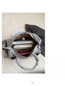Interior view of large capacity silver quilted tote bag showing lining and inner pockets