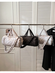 Detailed view of beige black and grey quilted puffer bags with ruffled straps