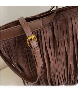 Détail de la boucle en métal doré réglable et de la bandoulière en cuir lisse du sac café