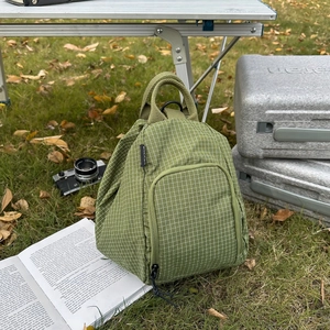 Grass green checkered nylon backpack for outdoors with a front zipper pocket