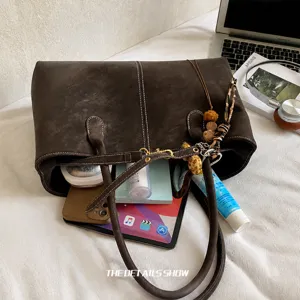 Detail view of the large capacity tote bag interior storing a tablet and daily essentials