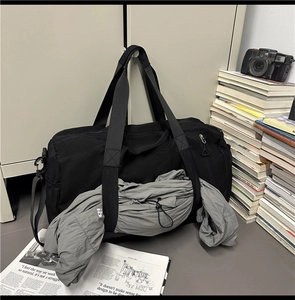 Macro shot of durable black nylon travel bag with side mesh pocket and sturdy handles