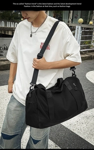 Detail of the black fitness travel bag with wide adjustable shoulder strap and side mesh pocket