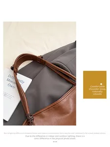 Primer plano de un bolso tote de cuero marrón con textura natural y correa ancha resistente