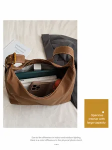 Macro view of the spacious interior of the brown leather tote bag with gold metal hardware