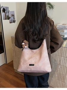 Pink marble texture tote bag with a brown teddy bear charm shown on a female model