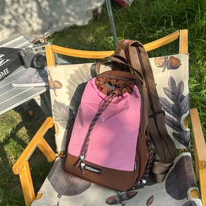 Dettaglio dello zaino con coulisse su una sedia da campeggio con design patchwork