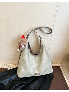 Detailed macro view of retro hobo bag with marble texture and cute puppy charm
