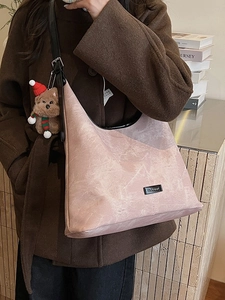Retro pale pink PU leather bucket bag with brown teddy bear charm and black strap