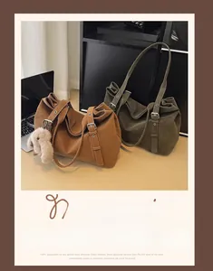 Retro matte leather tote bags in caramel and olive green with adjustable straps on a desk