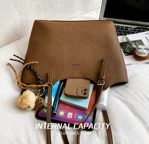 Brown lychee leather tote bag showing large capacity for tablet, phone, and cosmetics
