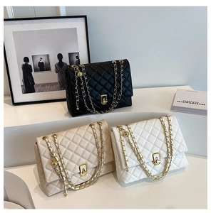 Detailed close-up of quilted chain bags in black, beige, and white with gold hardware