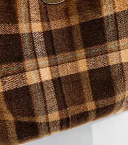 Close-up detail of soft plaid wool fabric showing the texture of the large tote bag