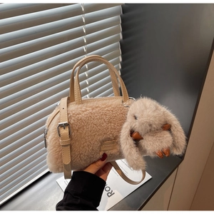 Detailansicht der beigen Plüschtasche mit Hasenanhänger und Fashion-Lederetikett