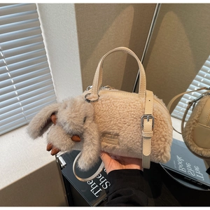 Detailansicht der beigen Plüschtasche mit weichem Lammfell-Imitat und Hasenanhänger