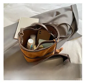 Macro view of the large capacity interior of this brown suede bucket bag with organizer
