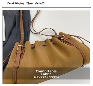 Detailed macro view of the premium brown pleated leather texture and drawstring closure