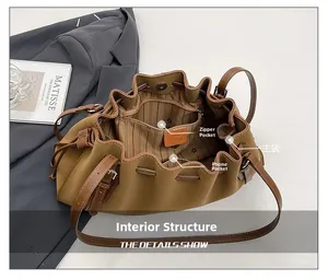 Detailed view of the brown tote bag interior with zipper pocket and striped lining