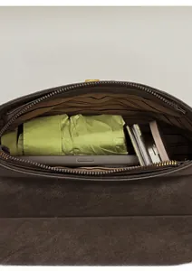 Top-down macro view of dark brown leather handbag interior showing storage capacity