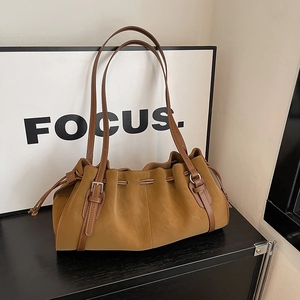 Vintage brown pleated tote bag with drawstring closure and stylish metal buckle straps