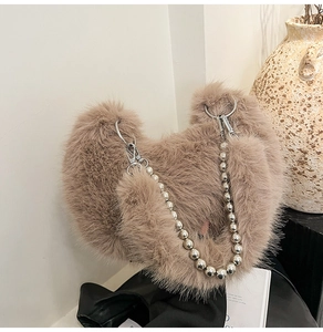 Detailed close-up of fluffy faux fur texture and silver beaded metal chain strap on bag
