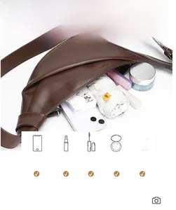Deep brown crescent bag showing spacious interior with phone and cosmetics