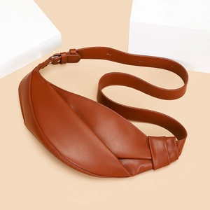 Detailed view of caramel crescent bag with pleated design and silver buckle