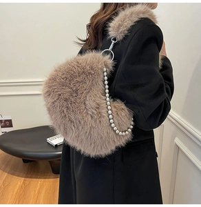 Detail of light brown faux fur shoulder bag with silver beaded chain and plush strap