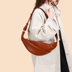 Close-up of the leather crescent crossbody bag featuring minimalist knotted strap details