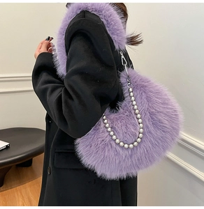 Close-up of purple plush crescent bag with chunky silver metallic bead chain strap