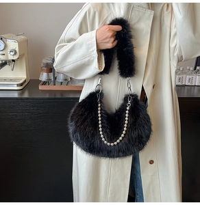 Close-up of black faux fur shoulder bag with silver beaded chain and plush handle