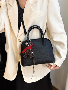 Classic black litchi pattern shell handbag with brown bear pendant and shoulder strap