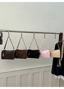 Detail shot of vintage leather underarm bags in five colors with gold hardware accents