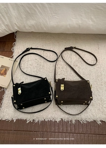 Detail shot of vintage crossbody bags with gold rivets and metallic lock hardware