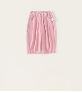Detail of pink cotton joggers featuring elastic waistband and functional side pockets