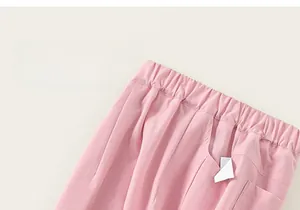 Detail of pink girls' trousers with elastic waistband and side pocket for kids