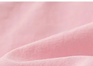 Detailed close-up of soft pink breathable cotton fabric texture for children's trousers