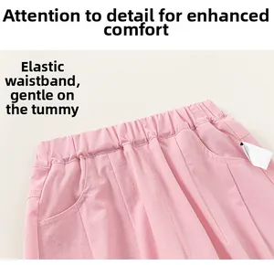 Detailed view of pink girls' cotton pants featuring an elastic waistband and side pocket