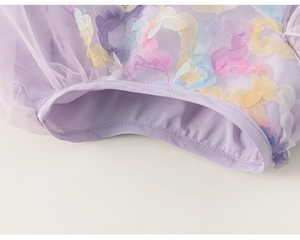 Close-up of 3D floral appliques and mesh fabric on girls purple fairy dress